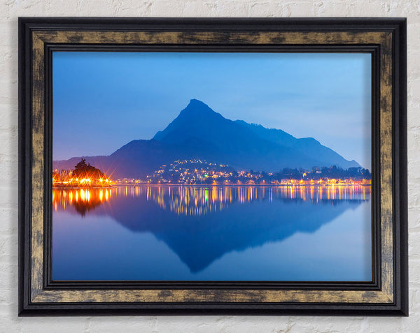 The Blue Mountain Reflects In The Tranquil Ocean Framed Print