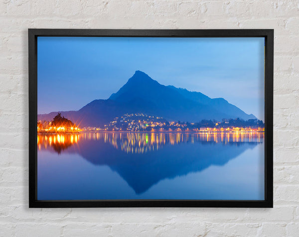 The Blue Mountain Reflects In The Tranquil Ocean Framed Print