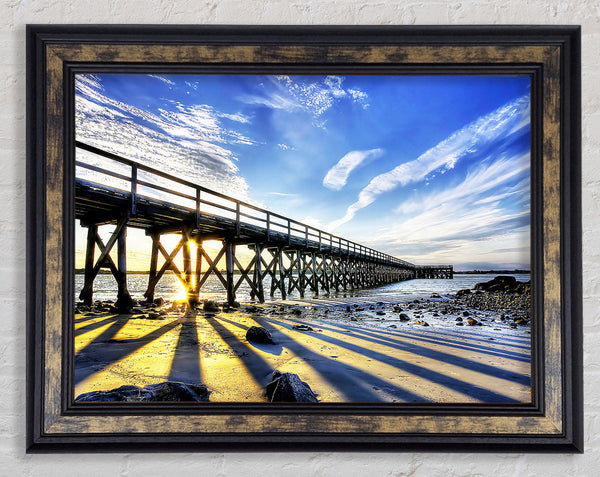 Sun Peaks Through The Pier Framed Print