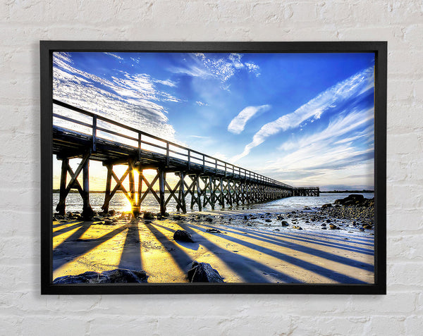 Sun Peaks Through The Pier Framed Print