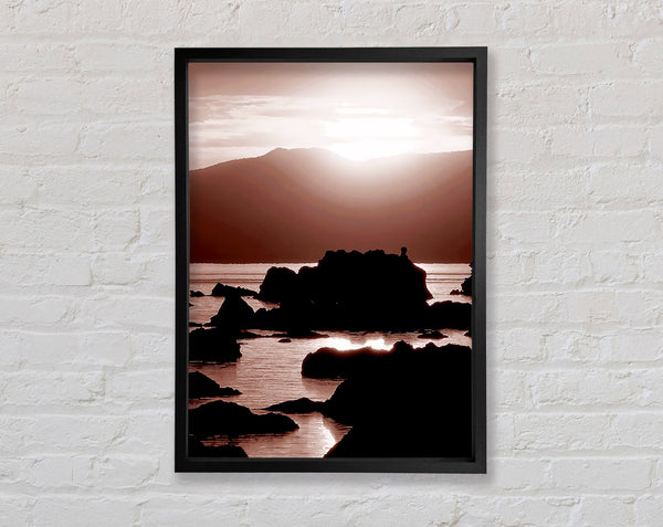 The Suns Mauve Ocean Rocks Framed Print