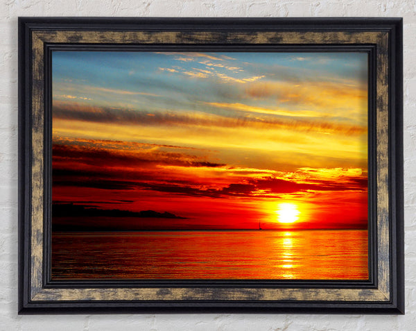 Distant Ocean Sailboat Sunset Framed Print