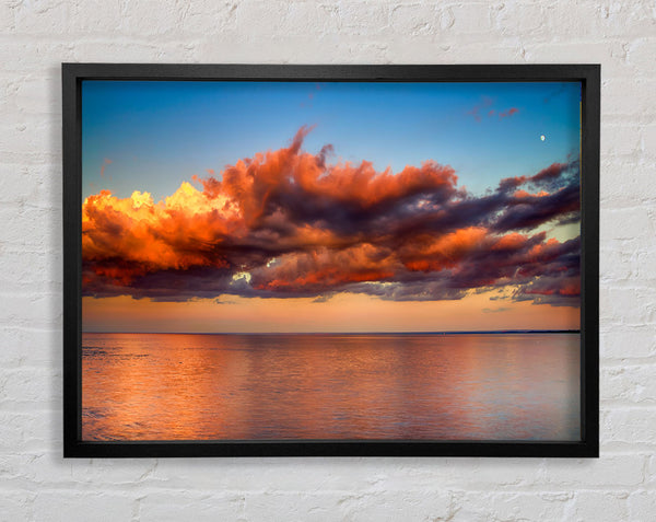 Red glowing clouds above the sea Framed Print