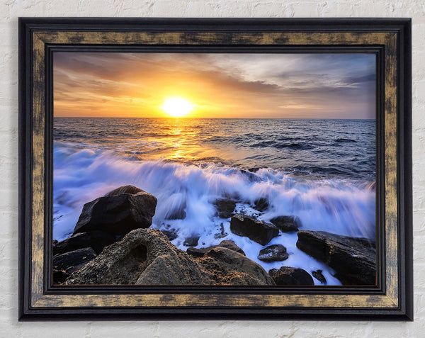 The waves crashing out at sea Framed Print