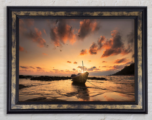 Sunset finishing boat on the beach Framed Print