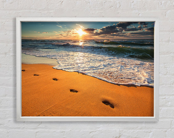 Footprints on the beach Framed Print