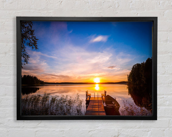 Rowing boat parked at the jeti Framed Print