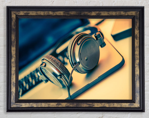 headpgones on the table Framed Print