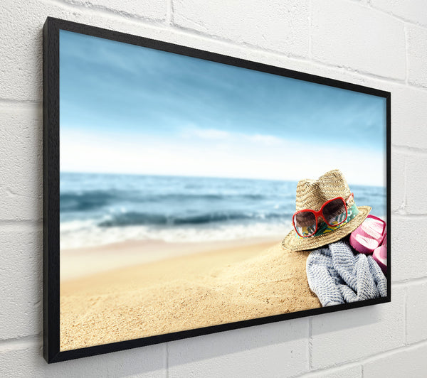 Sun hat and sunglasses on the beach