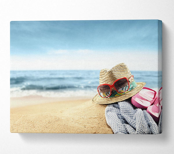  A Canvas Print of Sun hat and sunglasses on the beach Canvas Wall Art