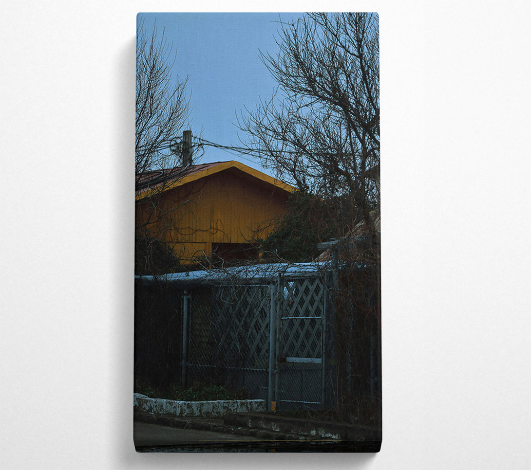  A Canvas Print of Yellow House Behind Branches Canvas Art