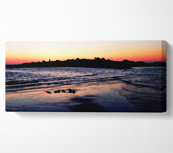 Sunset Behind The Ocean Rocks