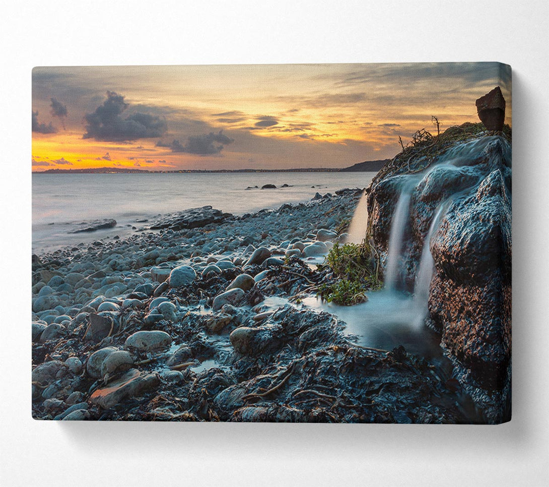  A Canvas Print of Water flows down the rocks into the sea Canvas Wall Art